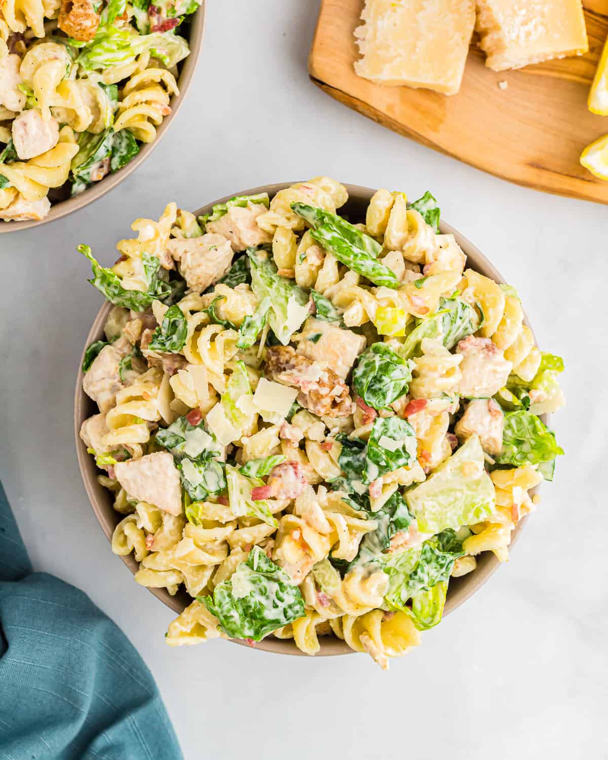 overhead view of large bowls full of chicken Caesar pasta salad.