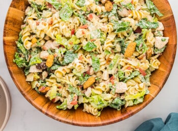 Chicken pasta salad in a wooden bowl.