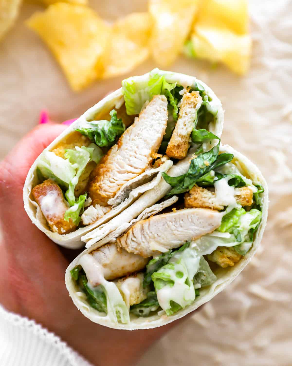 Close up on a Chicken Caesar wrap, cut in half.