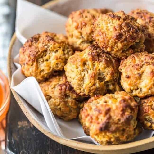 This classic Sausage Balls recipe is savory, cheesy, and tasty! These Bisquick sausage balls are the perfect appetizer for holidays or game day. Serve them with apricot sweet chili dipping sauce!