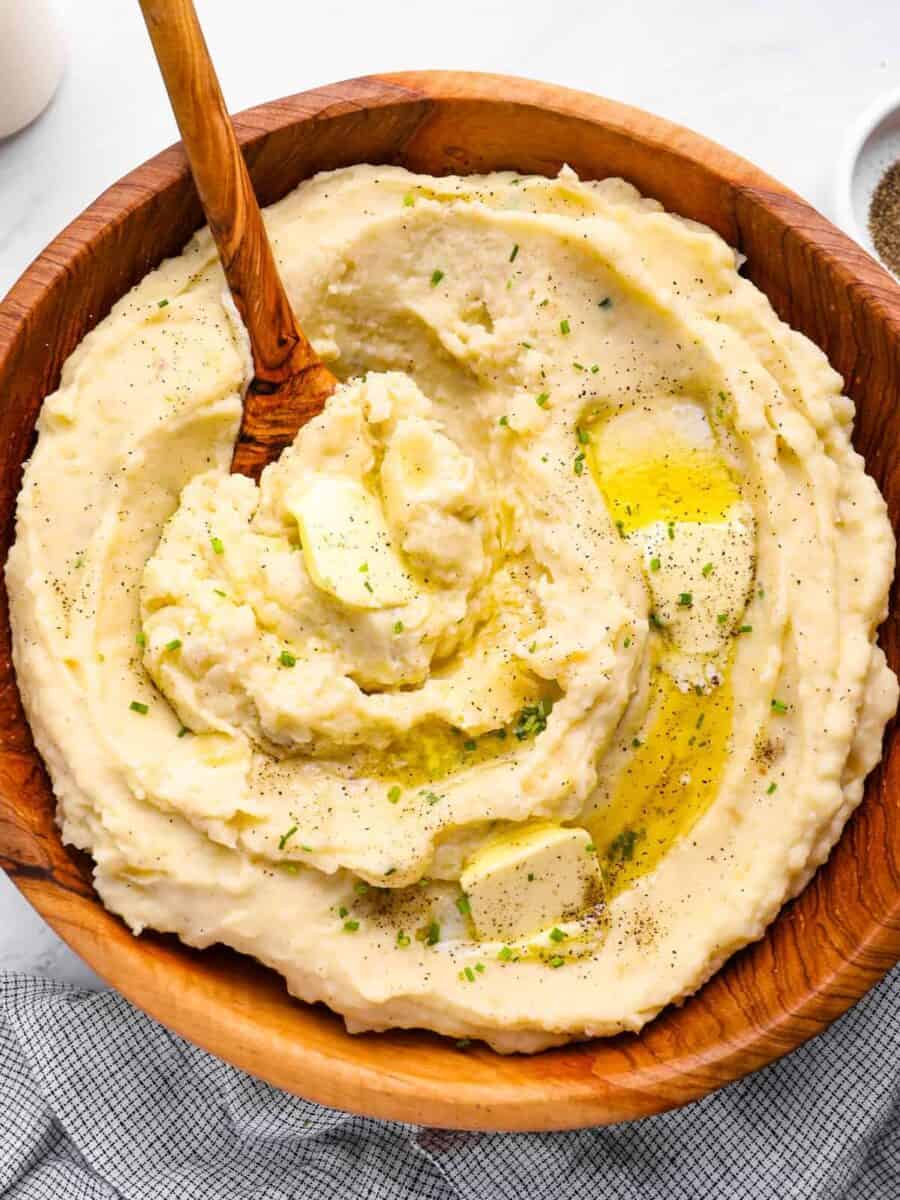 creamy crockpot mashed potatoes in a wooden serving bowl