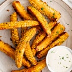 Corn on the cob served with dipping sauce.