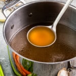 A pot of soup with a spoon in it.