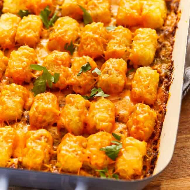 Cheesy tater tots in a baking dish.