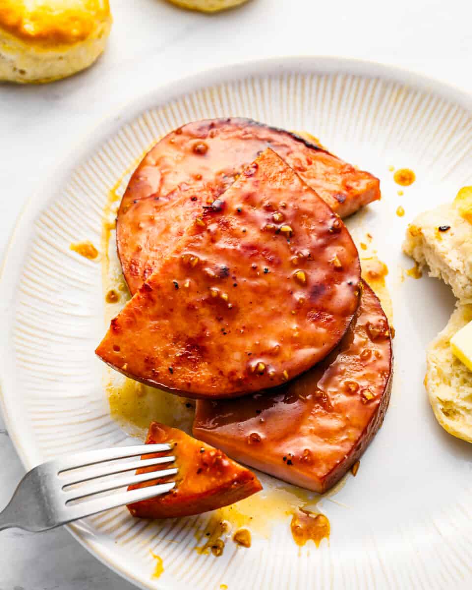 A plate of food with a fork and biscuits.