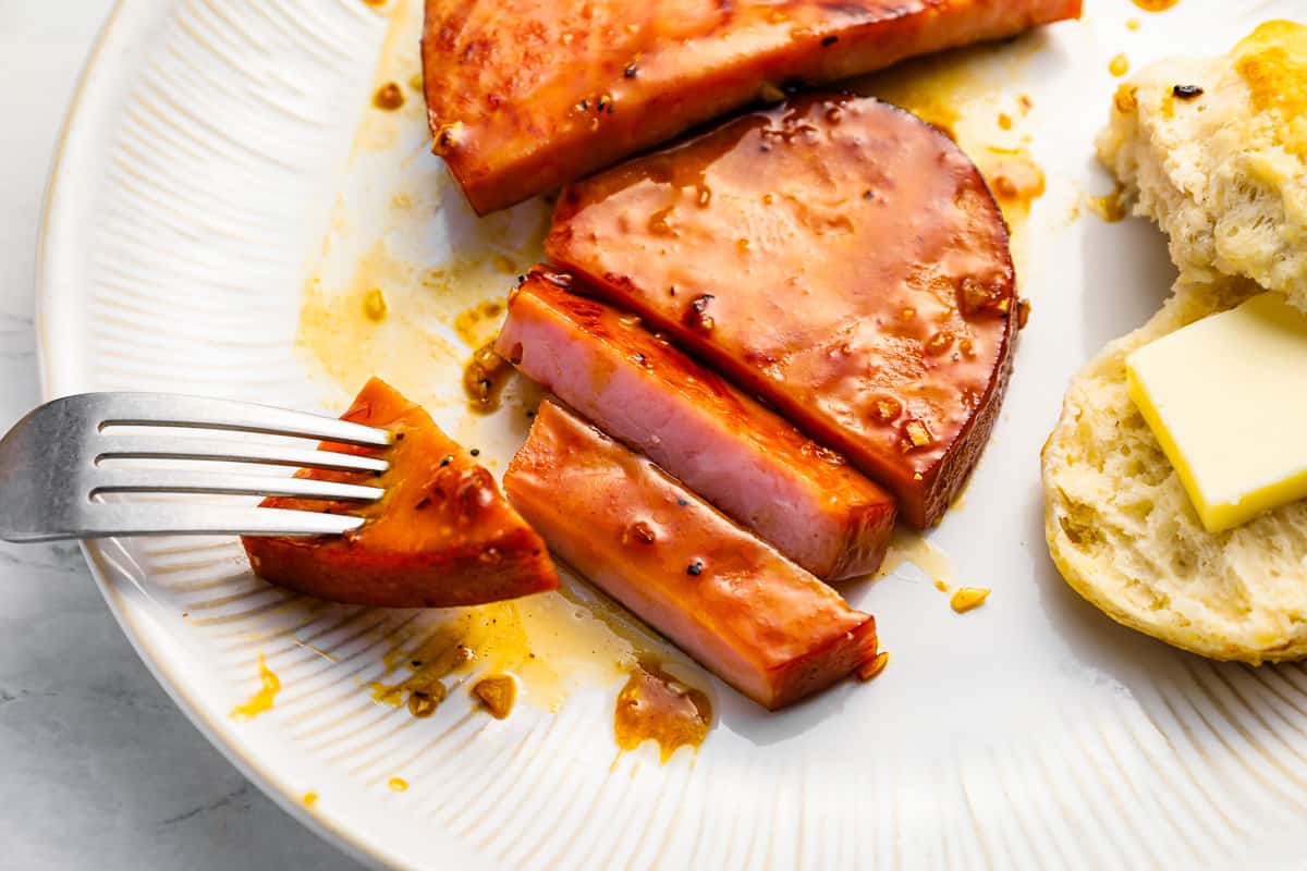 a ham steak sliced up and covered in glaze.