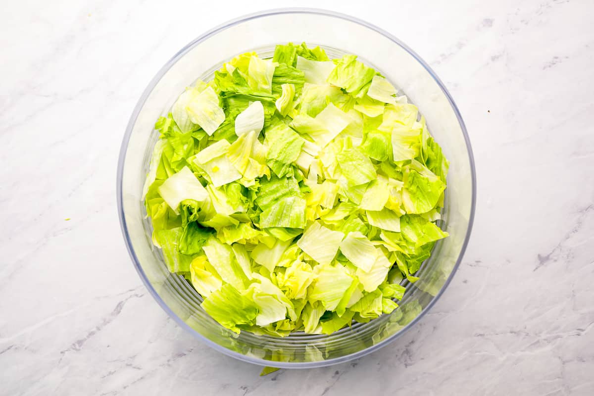 Shredded lettuce in a bowl. - 11