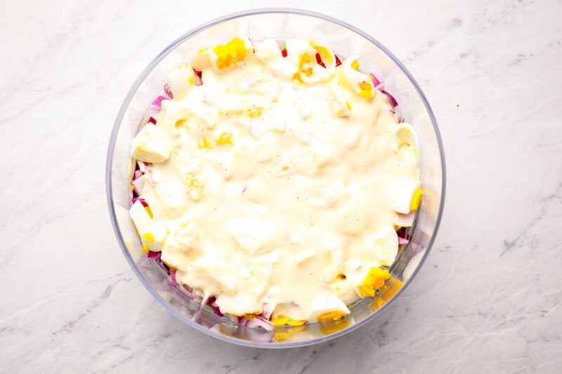 A clear bowl with a salad in it.