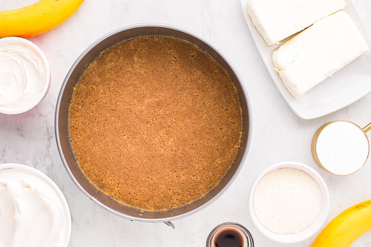 A pan with bananas and ingredients for a banana cake.