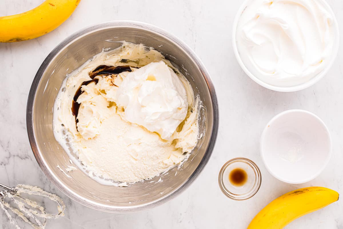 Whipped cream and bananas in a bowl.