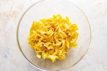 Yellow pasta in a glass bowl.