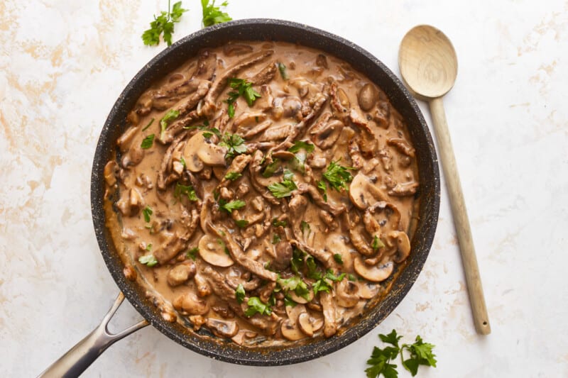 Mushroom risotto in a skillet with parsley.