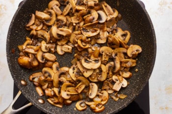 A frying pan with mushrooms in it.