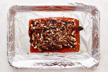 A piece of salmon on a piece of foil.