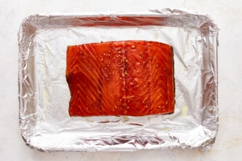 A piece of salmon is sitting on a piece of foil.