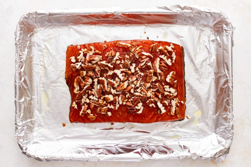 Smoked salmon with pecans on tin foil.