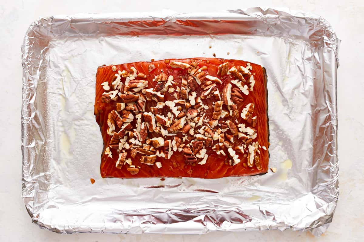 Smoked salmon with pecans on tin foil.