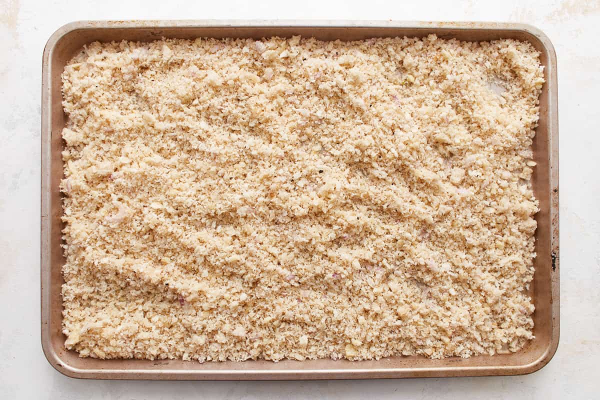 A baking pan filled with breadcrumbs.