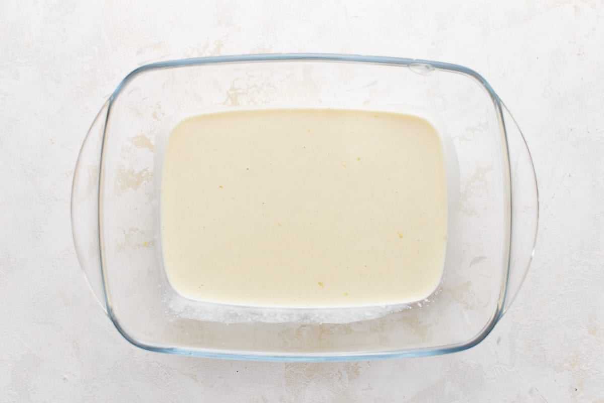 A glass bowl with a mayonnaise mixture in it.
