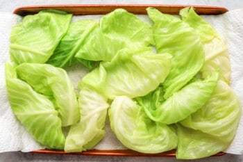 Cabbage leaves on a baking sheet.