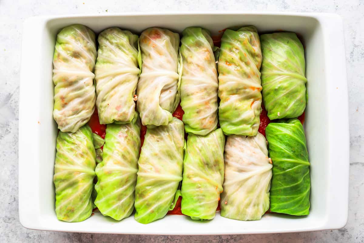 Cabbage rolls in a white dish.