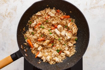 Chicken fried rice in a frying pan.