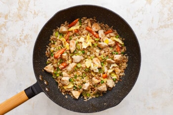 Chicken fried rice in a frying pan.