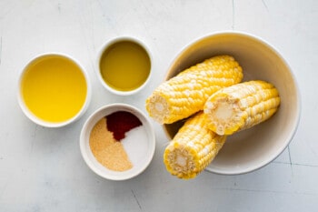 Corn ribs with seasonings in bowls.