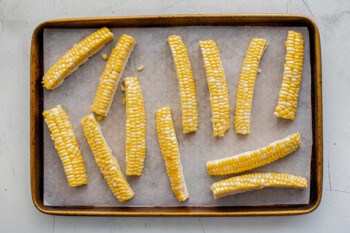 Corn ribs arranged on a baking sheet.