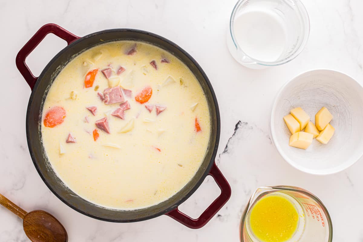 A bowl of soup with ingredients next to it.