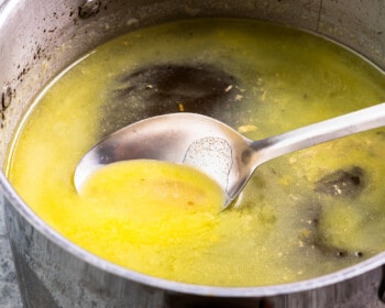 A pot of soup with a spoon in it.