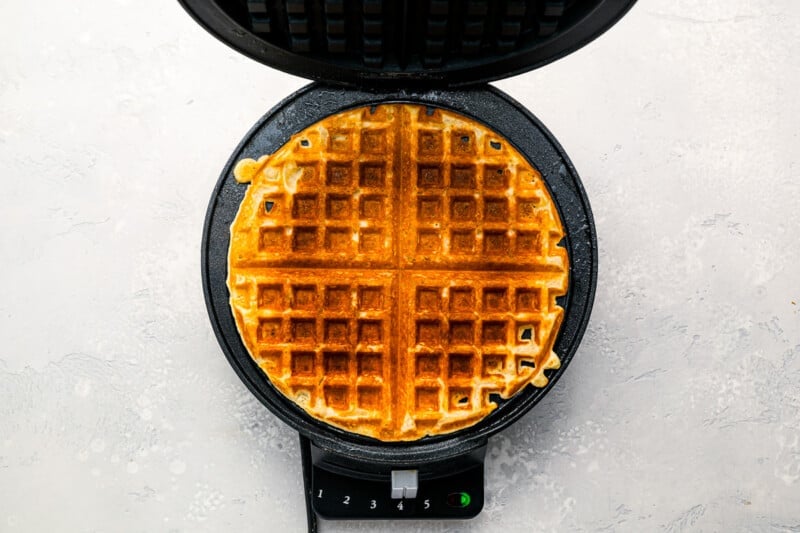 Waffles in a waffle maker on a white background.