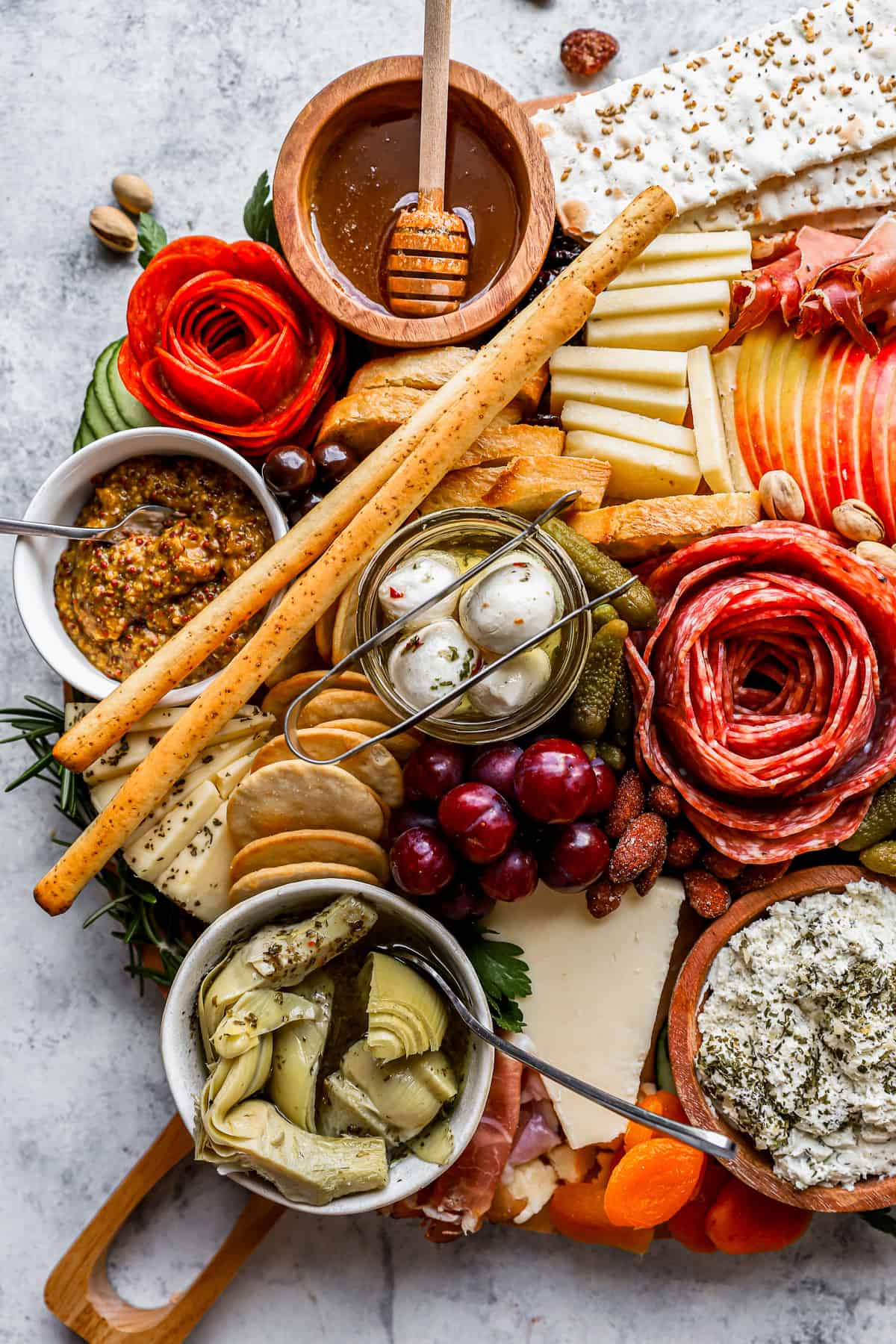 A charcuterie board with a variety of meats, cheeses, and crackers.
