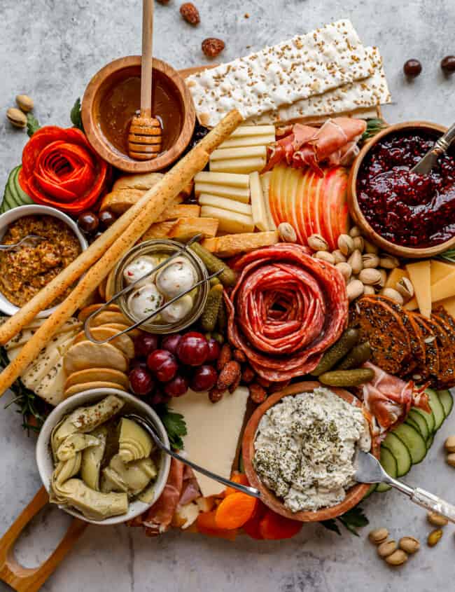 A platter with a variety of meats and cheeses.