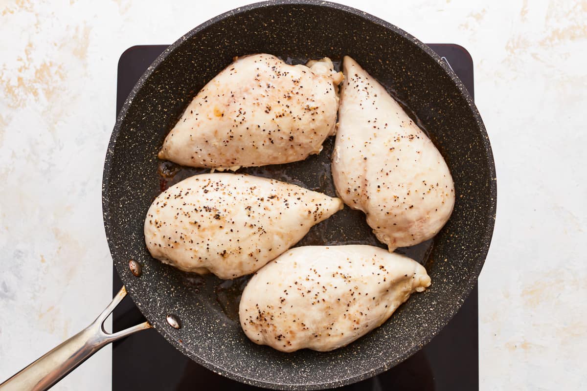 Chicken breasts in a skillet.
