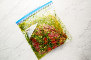 A bag of meat with herbs and spices in it.