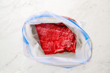 A piece of meat in a plastic bag.