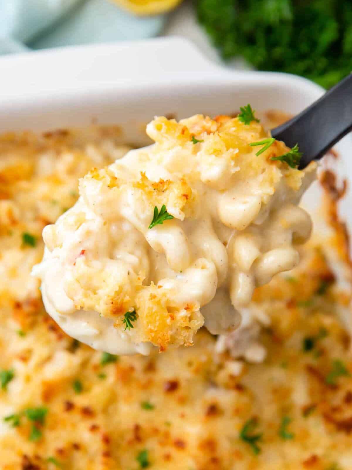 serving spoon lifting up lobster mac and cheese