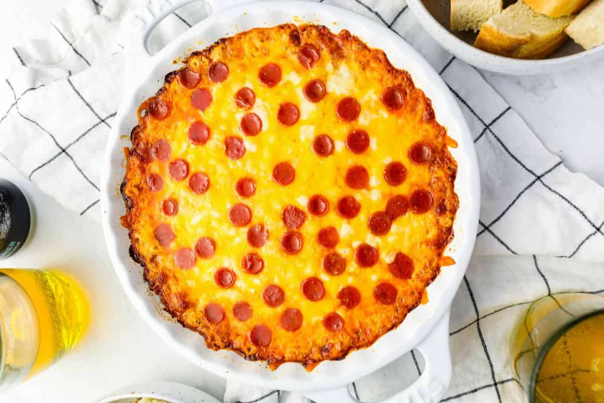 overhead view of cream cheese pizza dip in a white round baking dish.