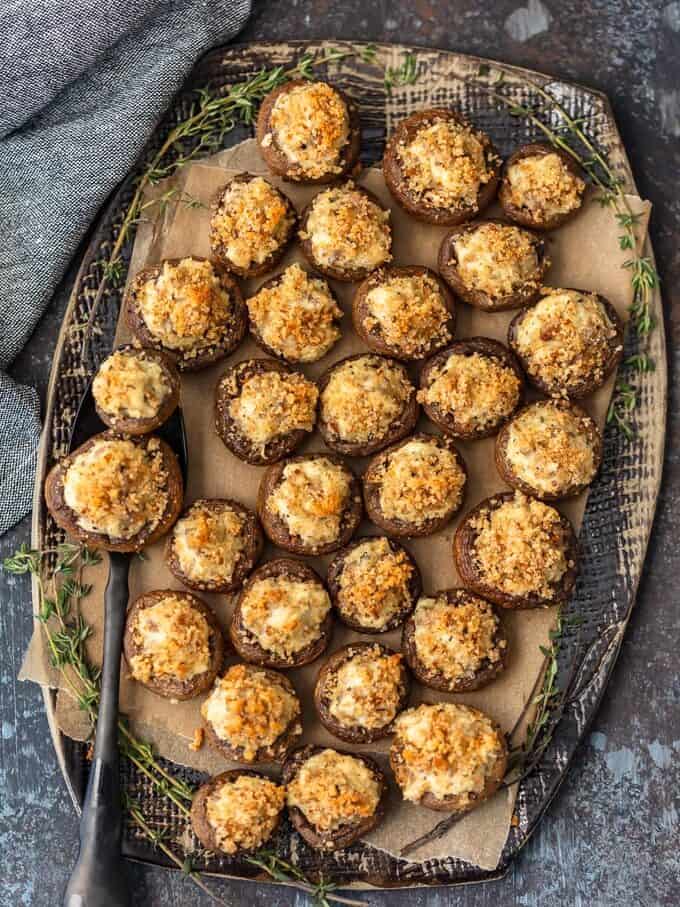 cheese and sausage stuffed mushrooms arranged on a serving platter