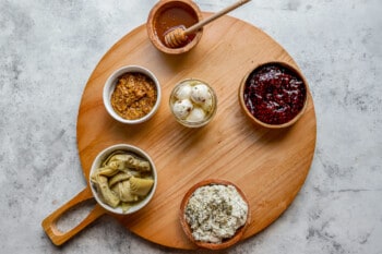 A wooden plate with different types of food on it.