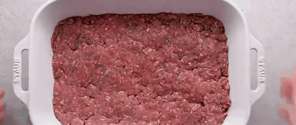 Ground beef in a white baking dish.