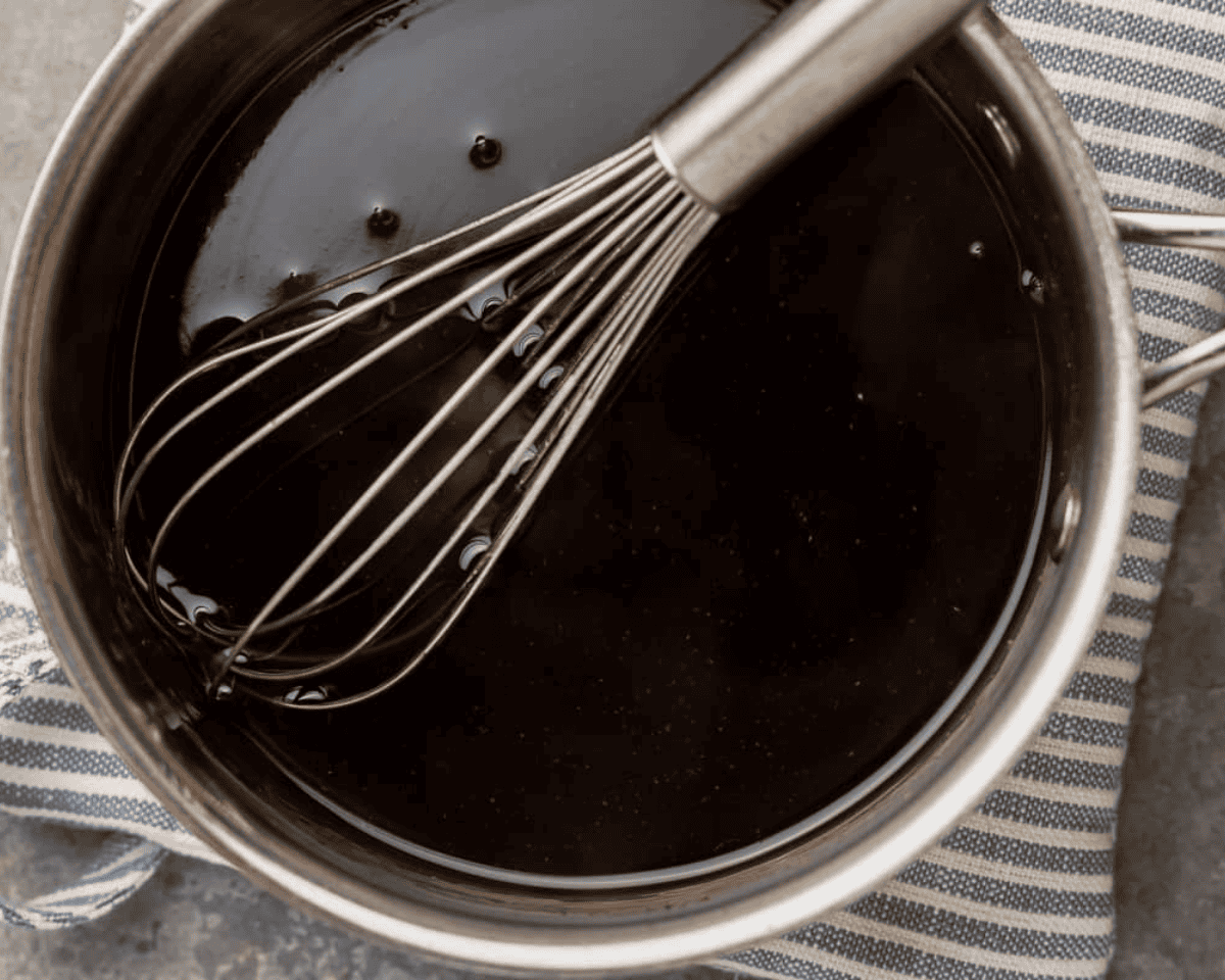 Stir fry sauce in a pot with a whisk. - 8