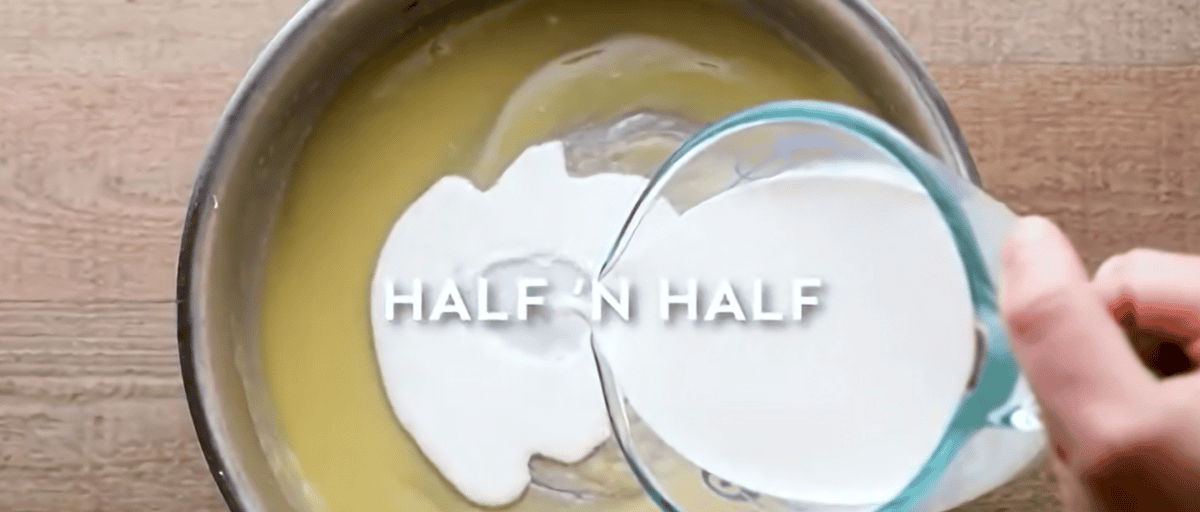 Adding cream to the white sauce. 