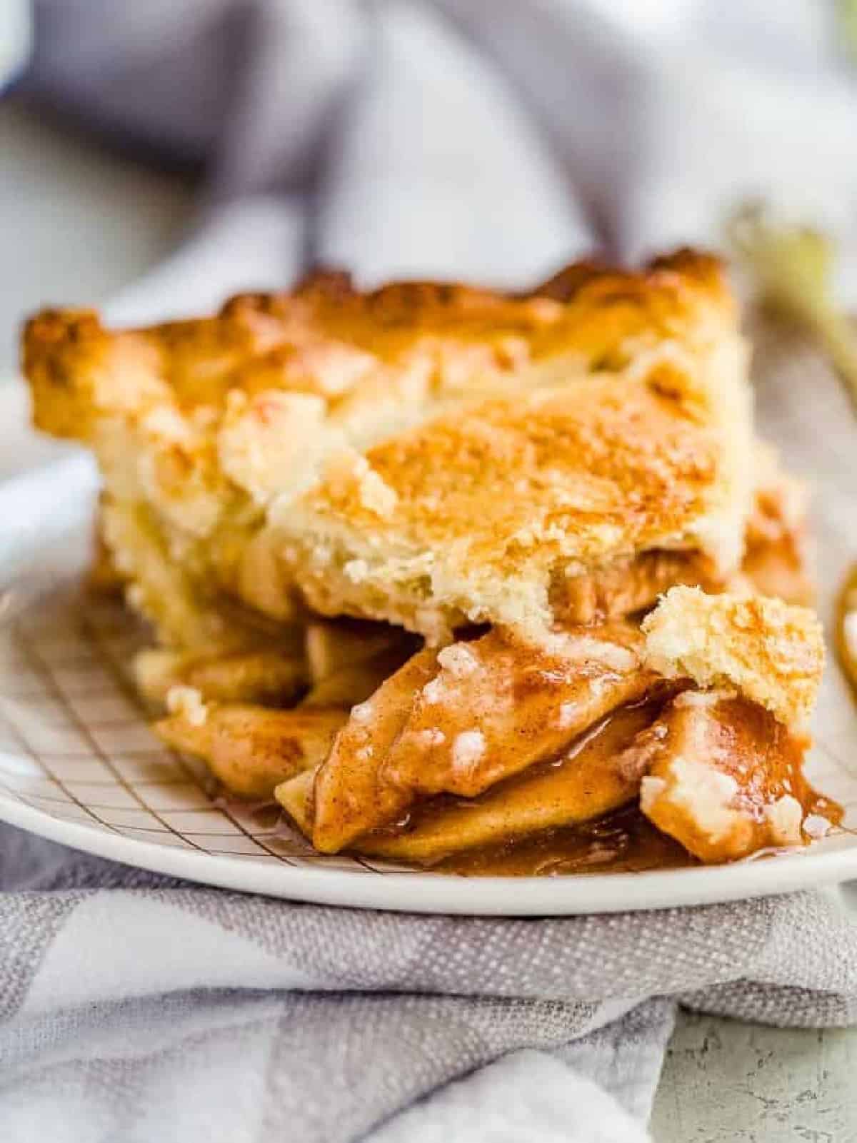 apple pie on a plate with a gray towel