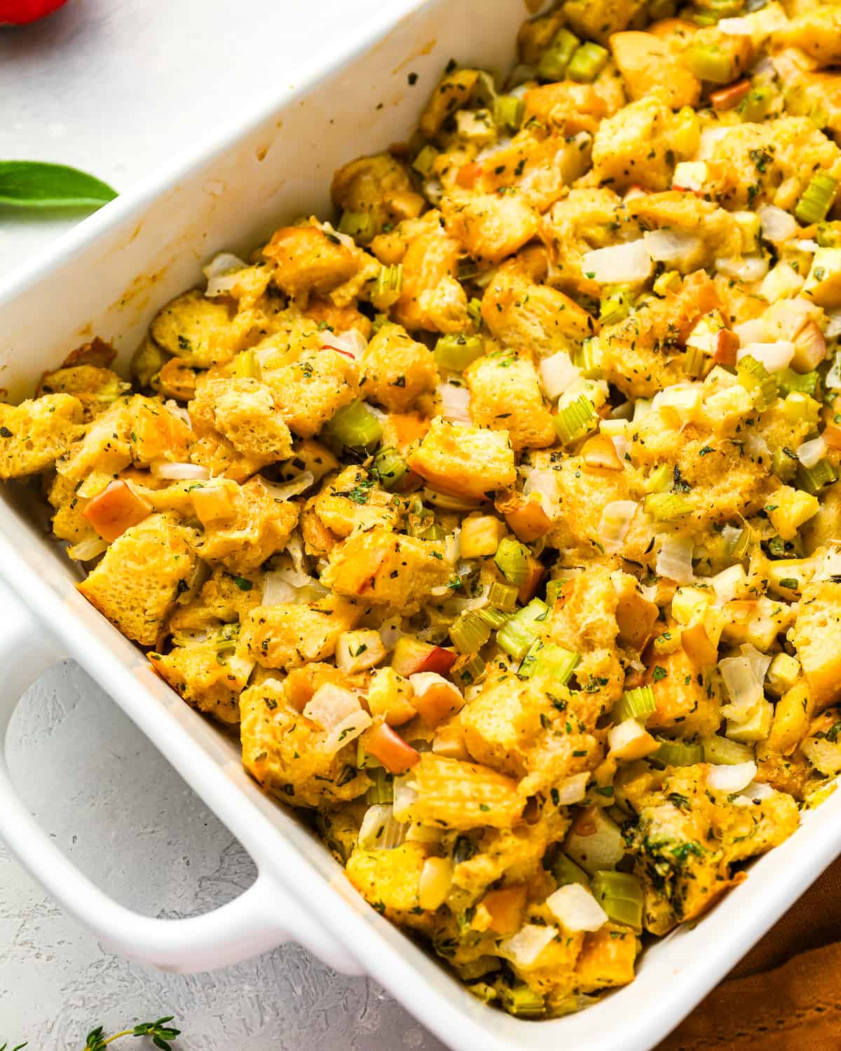 Apple stuffing in a white baking dish.