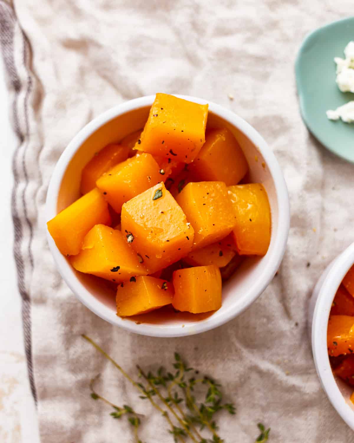 cubed butternut squash in a white bowl.