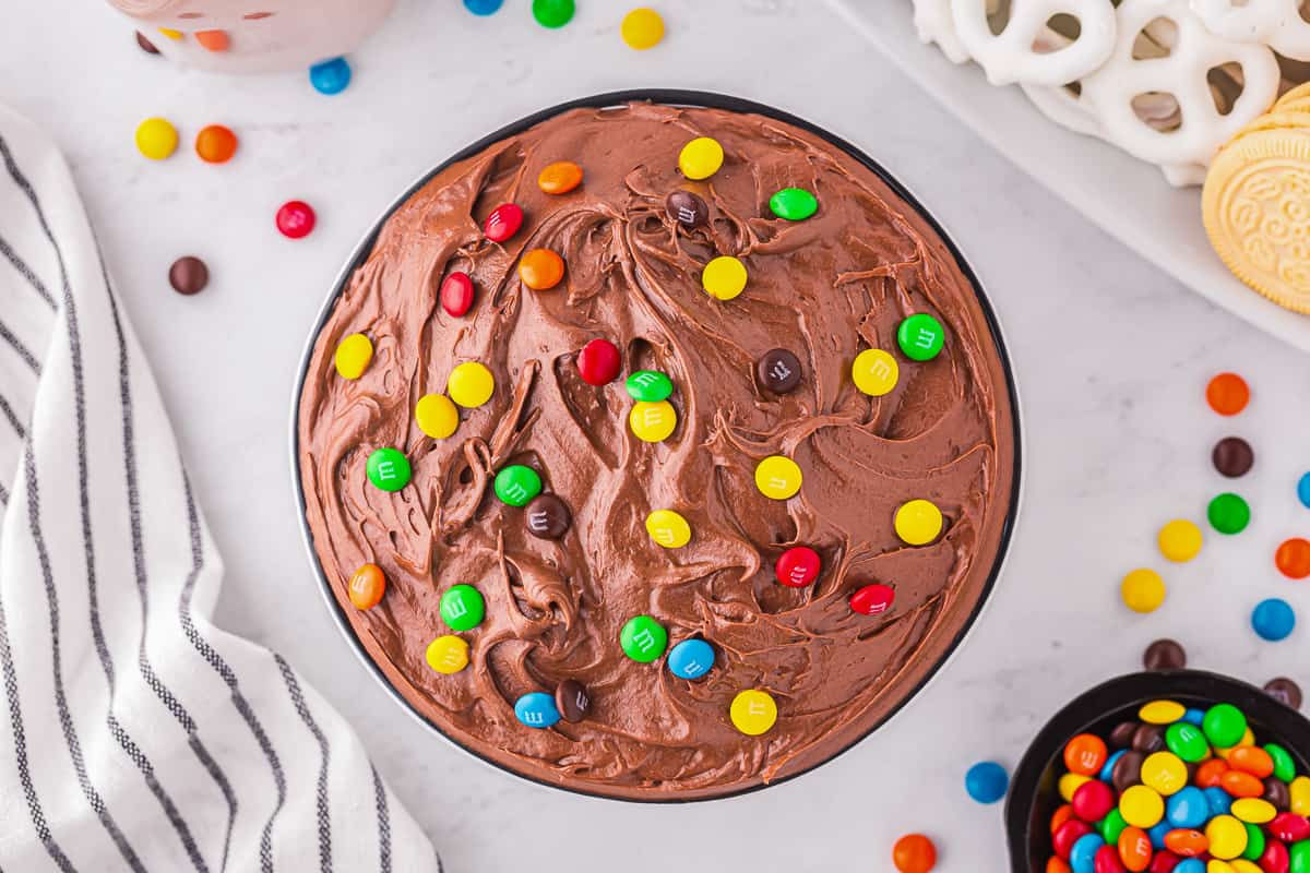 A bowl of brownie dip topped with M&Ms.