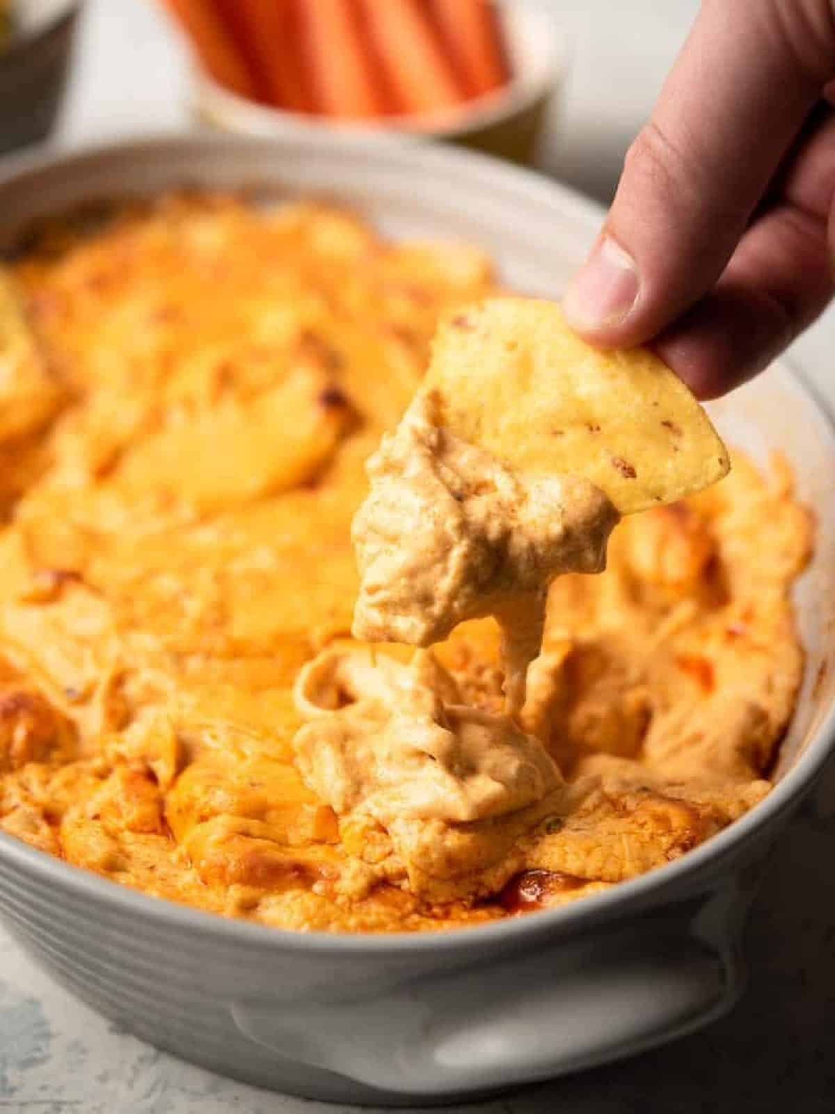 dipping chip in buffalo chicken dip