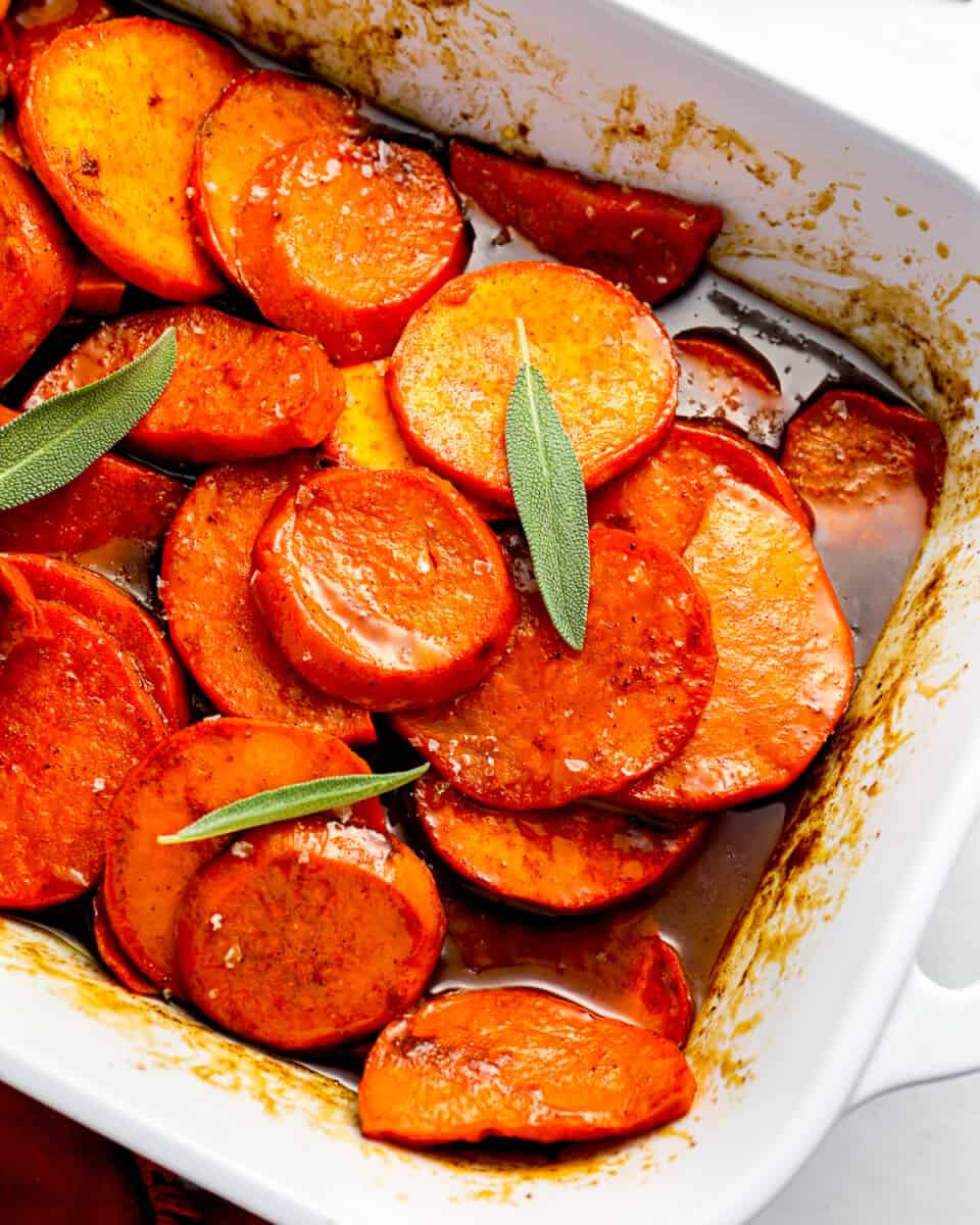 A white baking dish filled with candied yams.